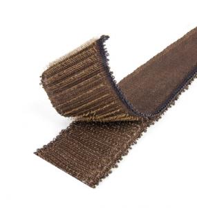 A close-up of a VELCRO® Brand HI-GARDE® Fastener, a brown, textured strip with a looped edge and partially rolled, resembling an industrial-strength hook-and-loop fastener.