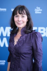 Director Traci L. Slatton in a purple embroidered jacket on the blue carpet at the Newport Beach Film Festival world premiere of her documentary HEROIC.