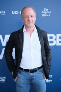 Master sculptor Sabin Howard in a black jacket and white shirt on the Newport Beach Film Festival blue carpet for the world premiere of HEROIC, the documentary about his National WWI Memorial sculpture.