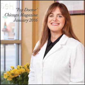 Dentist in white coat smiling near reception window at Healthy Smiles, Inc. in Chicago