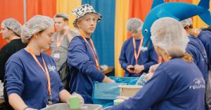 Young people distributing food and supplies during NCYC