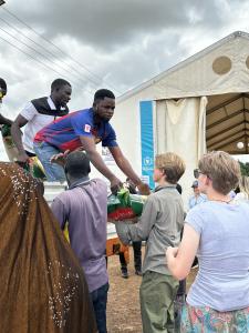 Members of National Youth Advisory Council assist in distributing food during NFCYM mission trip to Ghana in 2025.