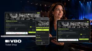 Laptop, mobile phone, tablet displaying the VBO Ticket Shop user interface. Behind the devices is an attractive woman holding a tablet in a performing arts theatre.