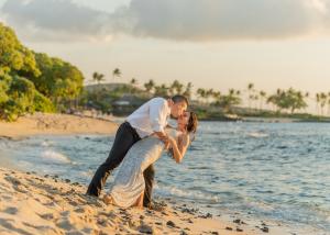 Couple dips on Kuki`o Beach in Hawaii after their wedding renewal ceremony with Kona Wedding Officiant®.