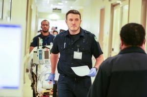 Emergency medical staff moving a patient along a corridor at KFSH in Riyadh