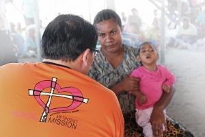 Dr Francis Loh delivering healthcare to Nepal flood victims