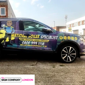 Black vehicle displaying yellow and purple graphics and contact details
