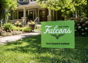 Green Oak Park Falcons girls fastpitch softball yard sign displayed on a front lawn in front of a house.