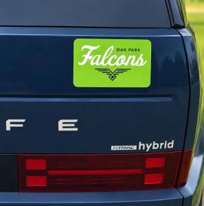 Green Oak Park Falcons team magnet with white lettering and a black falcon logo displayed on the rear of a dark blue Ford hybrid SUV.