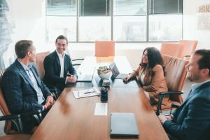 Four members of the PDS Planning leadership time consult around a conference table.