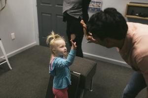 dr bobby fano interacting with child patient in office giving a high five