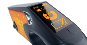 Close-up of the Arkade Gaming Gun touchscreen interface displaying an orange digital loadout menu and directional control pad.