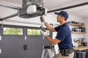 Garage door opener repair technician servicing an overhead door motor in Santa Clarita CA.
