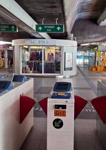 The Loft Bespoke Tailor shopfront seen from the ticket gates inside BTS National Stadium Station