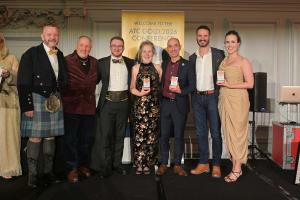 Photo of group of people on stage accepting awards