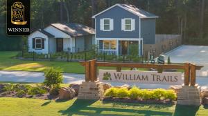 William Trails community entrance monument in Willis, Texas, with the 2026 Houston’s Best PRISM Awards winner badge