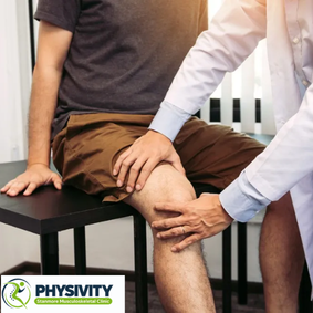 Physiotherapist examining a patient's knee during treatment