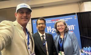 Eddie Kolos, Heidi McConnell, and Dr. Rajiv Saini at the H2Ocean exhibition booth during the CPRIT Cancer Conference 2026, discussing sea salt-based oral care innovations.
