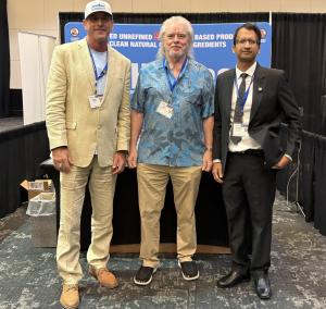 Mike Morrissey, Senior Advisor for Fiscal Policy to Texas Lieutenant Governor Dan Patrick, with Eddie Kolos, H2Ocean CEO, and Dr. Rajiv Saini, Chief Scientific Officer, at the H2Ocean booth during CPRIT Cancer Conference 2026.