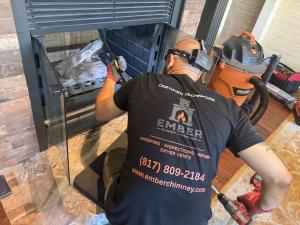 Ember Chimney & Fireplace technician performing a chimney sweep in Colleyville, TX