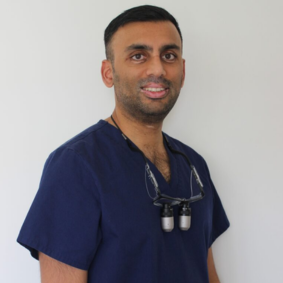Dr Tilak Patel wearing dental scrubs at Hanwell Dental