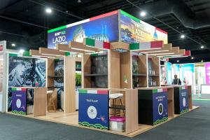 Anvet Group stand with red and yellow fascia, a bottle-shaped display and meeting space.