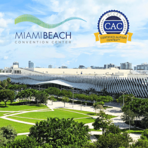 Miami Beach Convention Center with CAC Certified Autism Center badge, surrounded by green lawns and trees under a blue sky.