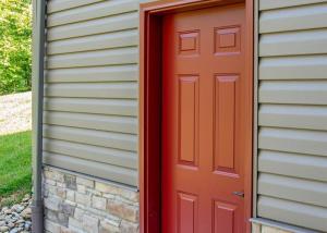 image showing siding replaced around a red door