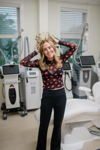 Provider smiling in a treatment room at United Medical and Aesthetics with aesthetic devices in the background