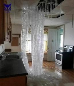 Kitchen with ice formed from water pouring through the ceiling after a frozen pipe burst