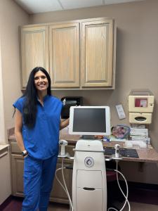 Team member standing beside the Candela Matrix system at Dr. Gil R. Villanueva, MD, FACOG in San Antonio