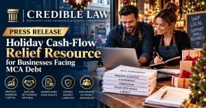 Credible Law holiday cash-flow relief press release image showing two small business owners reviewing merchant cash advance documents and finances in a decorated retail store.