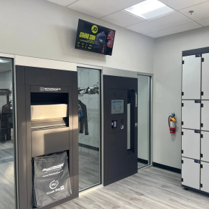 Interior of Martinizing Cleaners in Frisco, Texas, featuring a 24/7 automated garment drop-off kiosk, pickup system, and secure lockers for convenient, around-the-clock dry cleaning access.