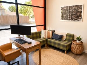 Private therapy office at Heights Behavioral Health in the Houston Heights, with a desk, sofa, and natural light, used for gambling addiction counseling
