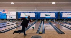 A bowler in a Bowling for Beds shirt releases a green ball down a lane, with sponsor banners for James Hardie / TimberTech, Trex and Doman Lumber above the pins.
