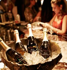 Bella Principessa Prosecco ceramic-painted bottles in a silver ice bucket at a bar