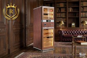 Luxury electric humidor cabinet with interior LED lighting and Spanish cedar shelves displaying cigar boxes in a classic wood-paneled room.