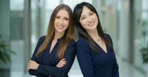 The two co-founders of NextGen Advising standing back to back in an office hallway