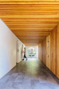 Guest walking through the ceremonial hallway at the Inn at Moonlight Beach in Encinitas, California.
