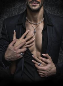 VERGEZ™ silver Cross of Return pendant with blue gemstone, Freedom Chain necklace and matching rings worn by a couple dressed in black.