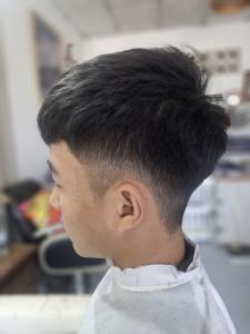 Short men's cut with a fade at the sides, seen from the side, at Hair & Beauty Salon in Chiang Mai