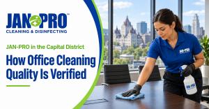 A JAN-PRO Cleaning & Disinfecting professional cleaning a conference room table in a modern Albany, New York office, illustrating consistent office cleaning and quality verification.