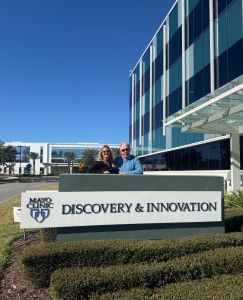 Alane Paulley CEO of AuraWell with Woody Blackburn, former professional golfer at Mayo Clinic, pictured outside
