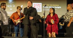 Jazz Hands For Autism musicians singing and playing guitar on stage