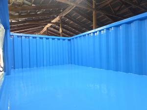 Blue polyurea membrane coating the interior of a shipping container pool