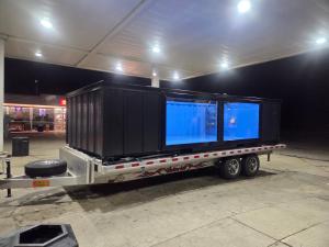 Finished shipping container pool on a flatbed trailer