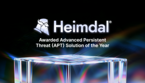 Heimdal logo and award banner: ‘Awarded Advanced Persistent Threat (APT) Solution of the Year,’ above a glass cube reflecting colorful light against a black background