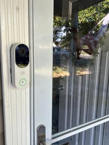 HYVE video doorbell camera mounted beside the front door of a Lehi home