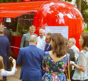 Outside the red food truck serving Texas Mexican tacos, Chef and Food Writer Adán Medrano mingles with Russian guests.