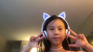 Alison Tran, age 8, plays the piano at home for a virtual audience.